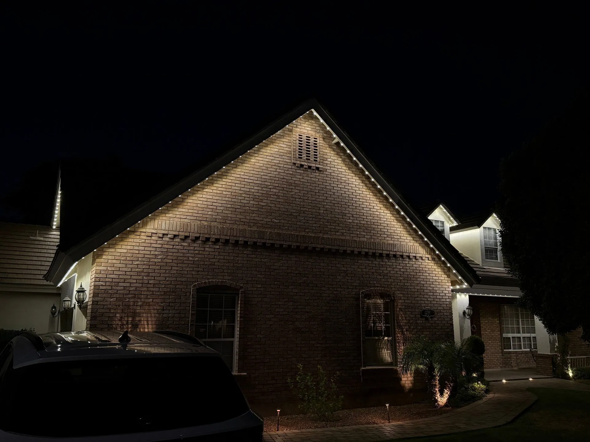 Permanent roofline lighting on brick home