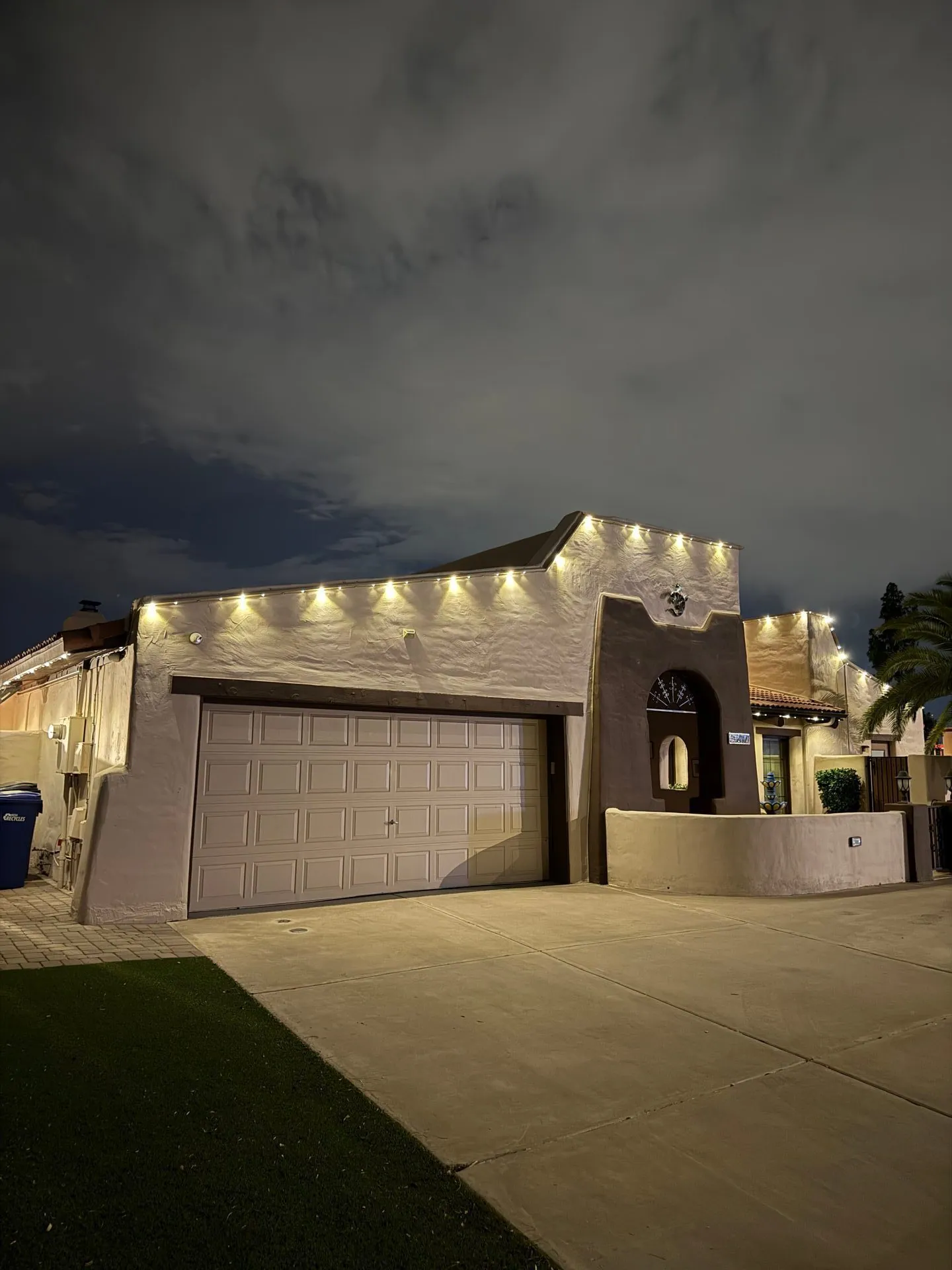 Garage and roofline lighting on stucco home