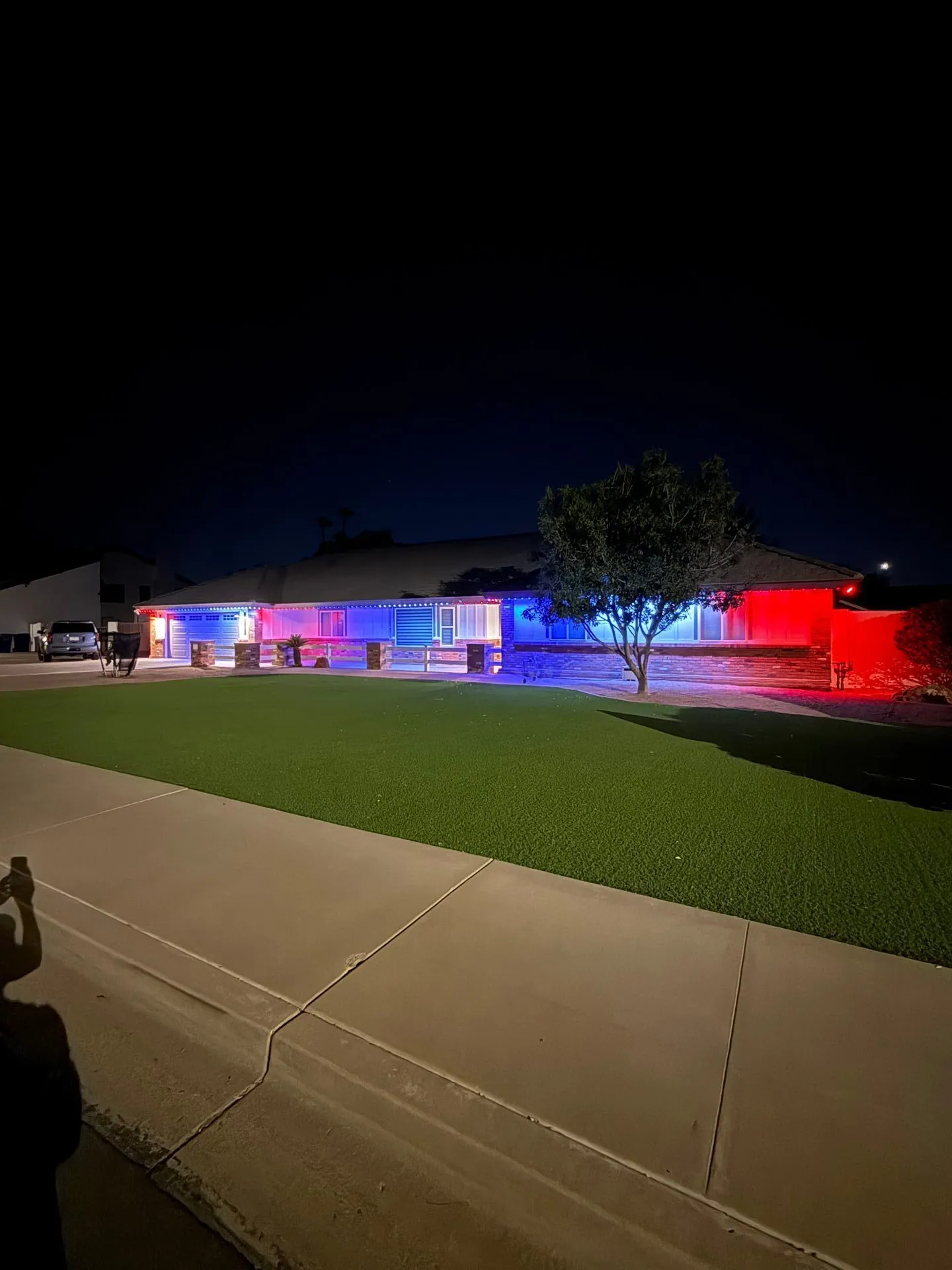 Red and blue permanent lighting on ranch home