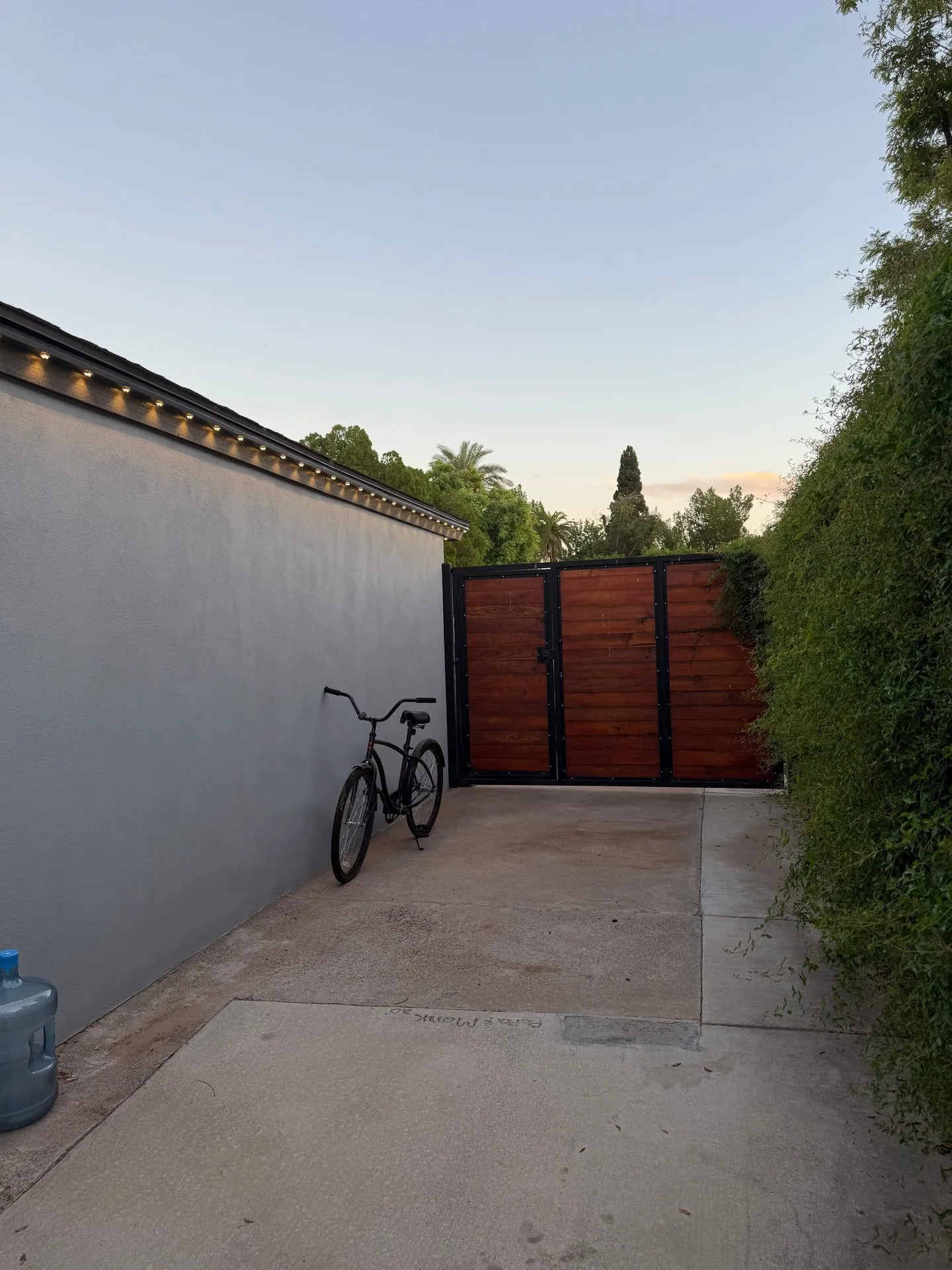 Permanent lighting on side wall with wooden gate