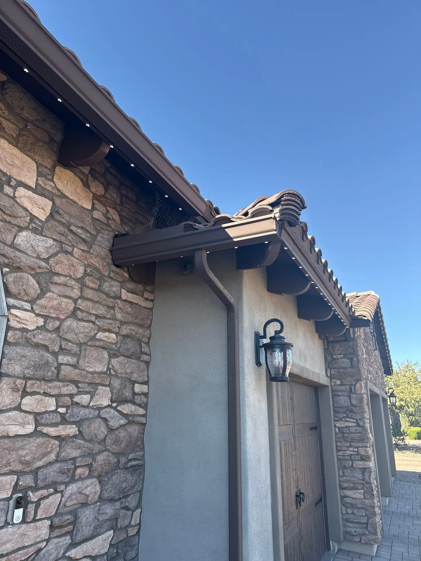 Close-up of permanent lighting on stone and stucco exterior