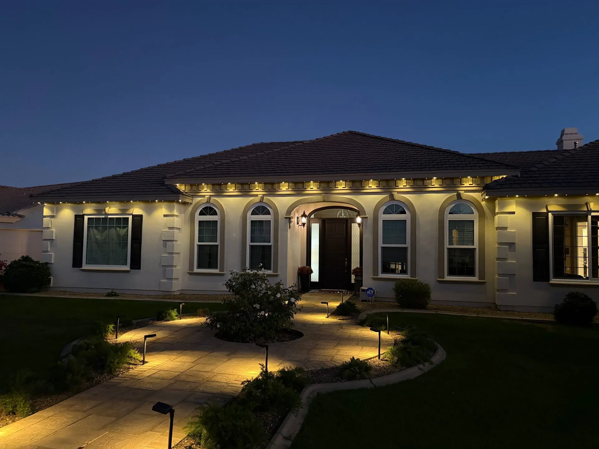 Warm white downlighting on Mediterranean-style home