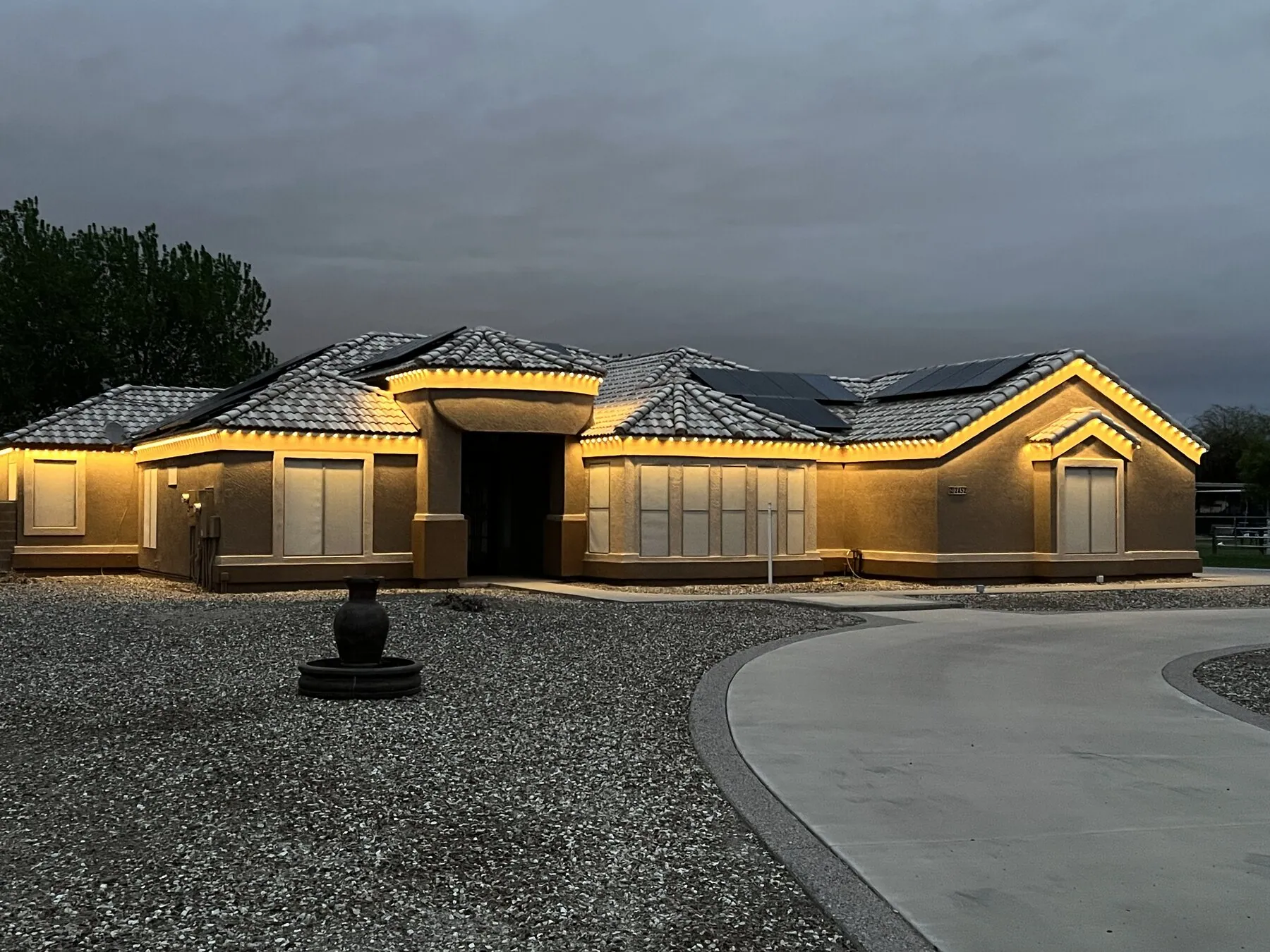Warm white lighting on a single-story desert home at dusk