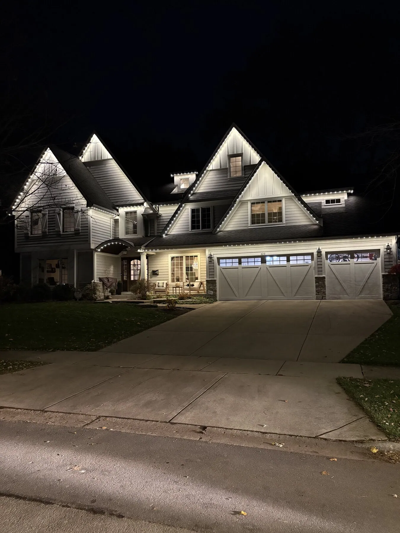 White roofline lighting on a home with steep gables