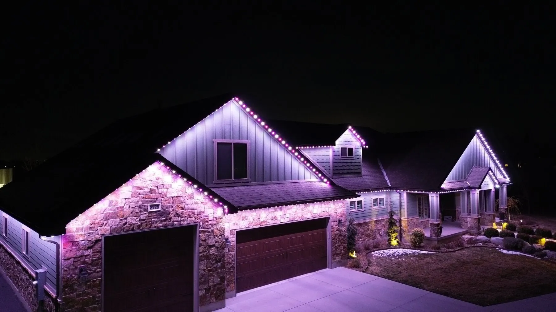 Soft violet roofline lighting on a home at night